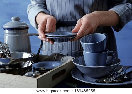 Closeup of female hands holding saucers