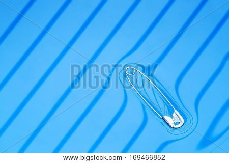 Physical experiment - pin floating on water surface.