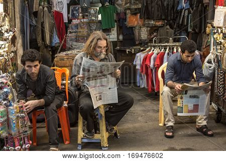 TEHRAN IRAN - AUGUST 14 2016: Iranian merchants reading newspapers in Farsi in Tehran main bazaar
