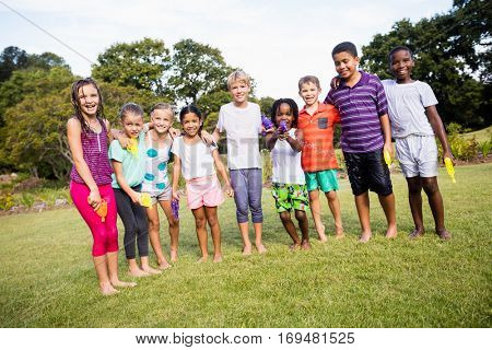 Kids posing together during a sunny day at camera at park