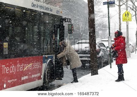 BRONX NEW YORK - JANUARY 7: Woman boarding bus during snow storm. Taken January 7 2017 in New York.