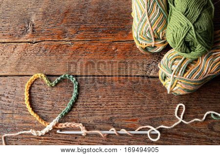 A top view image of crochet yarn in a heart shaped symbol.