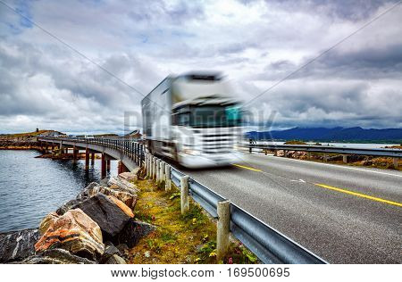 Truck and highway at sunset. Truck Car in motion blur. Atlantic Ocean Road or the Atlantic Road (Atlanterhavsveien) been awarded the title as 