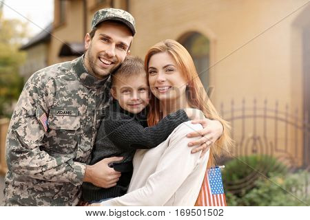 Soldier reunited with his family on a sunny day