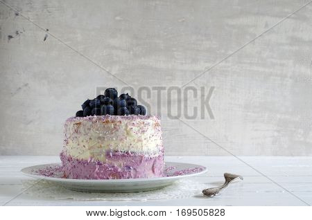 fresh home made bluebarry cake with purple cream cheese and coconut flake