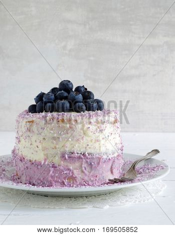 fresh home made bluebarry cake with purple cream cheese and coconut flake