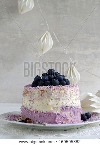 fresh home made bluebarry cake with purple cream cheese and coconut flake