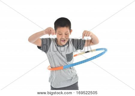 Asian boy playing with the hulahoop on a white background