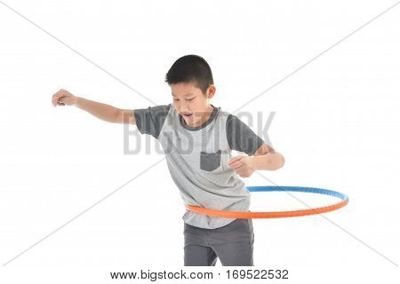 Asian boy playing with the hulahoop on a white background