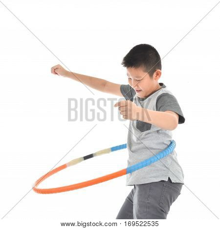 Asian boy playing with the hulahoop on a white background