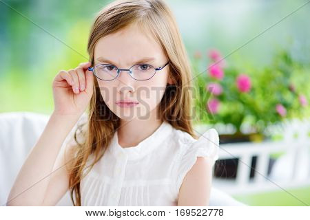 Moody Little Girl Wearing Eyeglasses Feeling Angry And Unsatisfied