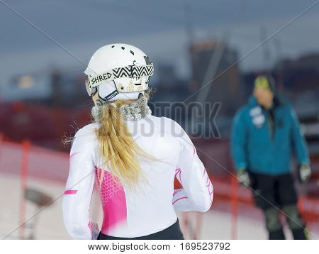 STOCKHOLM SWEDEN - JAN 31 2017: Rear view of Mikaela Shiffrin inspecting the ski used for parallel slalom at the Alpine Audi FIS Ski World Cup. January 31 2017 Stockholm Sweden