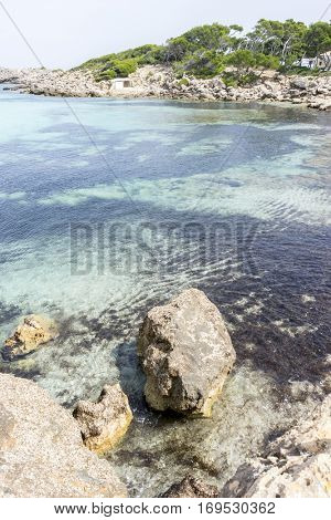 Vacation, Rocks by the Mediterranean sea on the island of Ibiza in Spain, holiday and summer scene