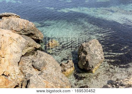 Rocks by the Mediterranean sea on the island of Ibiza in Spain, holiday and summer scene