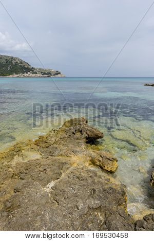 Rocks by the Mediterranean sea on the island of Ibiza in Spain, holiday and summer scene