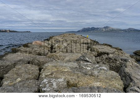 Breakwater by the Mediterranean sea on the island of Ibiza in Spain, holiday and summer scene