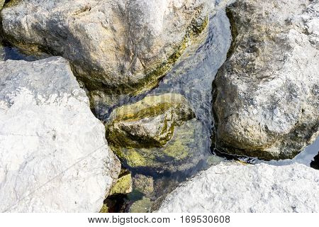 Rocks by the Mediterranean sea on the island of Ibiza in Spain, holiday and summer scene