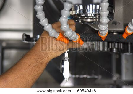 Man set up dial gauge for setting balance work after cutting of CNC