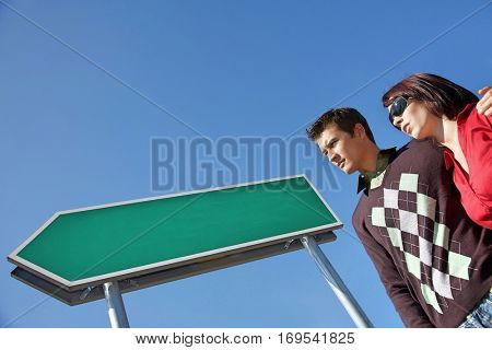 Low angle view of young couple with arm around