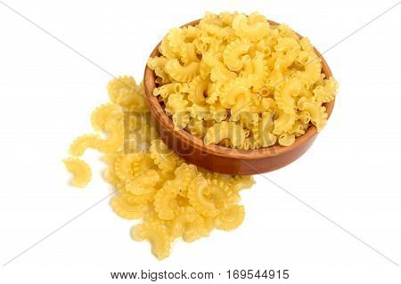 Macaroni (pasta) Galetti (horns with scallops) in a clay bowl on a white background. The raw product. Isolate object.