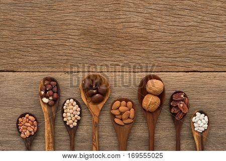 Different Kind Of Beans And Lentils In Wooden Spoon On Wood Background. Mung Bean, Groundnut, Walnut