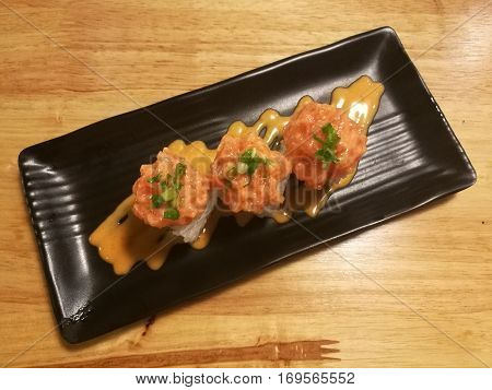 Fusion salmon sushi stuff with cucumber crab stick and mango Stylist food
