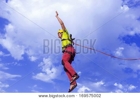 The first jump off the cliff with a safety rope.
