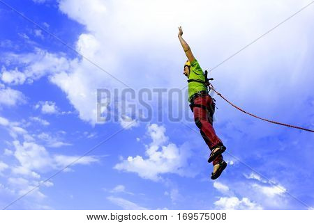 The first jump off the cliff with a safety rope.