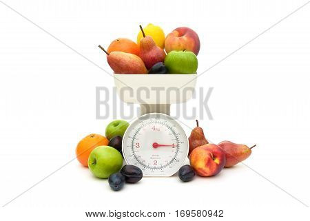 Fruit and kitchen scales isolated on white background. horizontal photo.