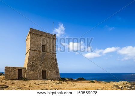 Malta - Ghajn Tuffieha watchtower at Golden Bay on a nice sunny summer day with clear blue sky