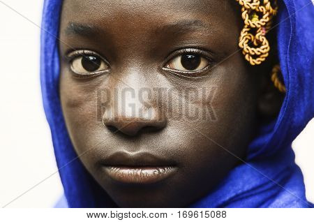 Young african girl in head scarf looking at camera isolated on white background