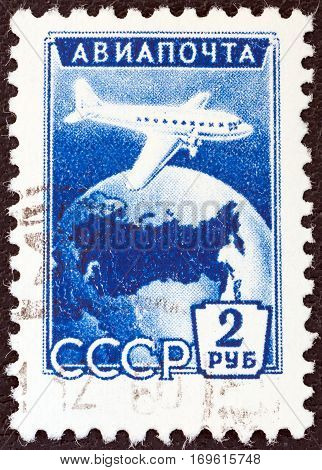 USSR - CIRCA 1955: A stamp printed in USSR shows Ilyushin Il-12 over Globe, circa 1955.