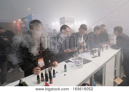 Moscow, Russia - December 9, 2016: People attend Vapexpo Moscow 2016 exhibition which presents new modern vape gadgets, liquids and flawours