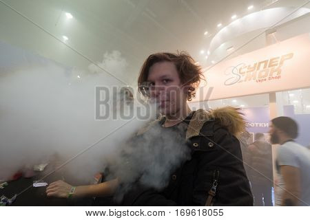 Moscow, Russia - December 9, 2016: People attend Vapexpo Moscow 2016 exhibition which presents new modern vape gadgets, liquids and flawours