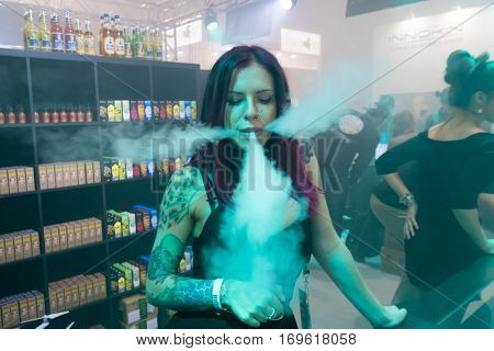Moscow, Russia - December 9, 2016: People attend Vapexpo Moscow 2016 exhibition which presents new modern vape gadgets, liquids and flawours