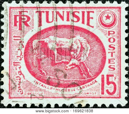 TUNISIA - CIRCA 1950: A stamp printed in Tunisia shows Horse (bas-relief), Carthage Museum, circa 1950.