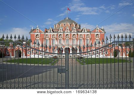 Petrovsky Travelling Palace with flag and fence at summer day in Moscow