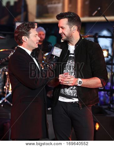 NEW YORK-DEC 31: Recording artist Luke Bryan (R) and Ryan Seacrest onstage during Dick Clark's New Year's Rockin' Eve at Times Square on December 31, 2015 in New York City.