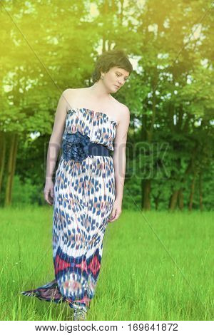 Adults Lifestyle and Recreation Concepts and Ideas. Brunette Caucasian Female Enjoying Her Time Outdoors On Nature.Vertical Image