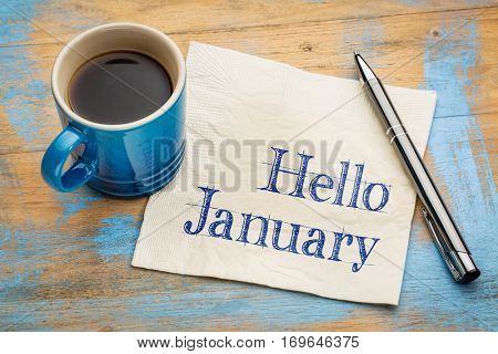 Hello January - handwriting on a napkin with a cup of coffee