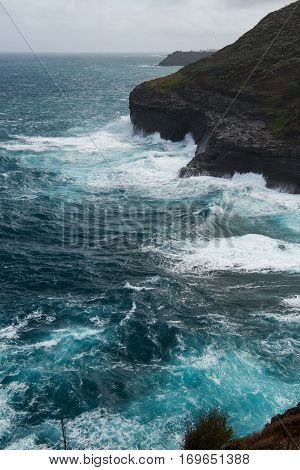 High waves crashing onto the cliffs at Kīlauea Point on Kauai Island Hawaii