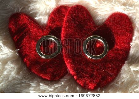 valentines background with rings on a white background of soft blankets