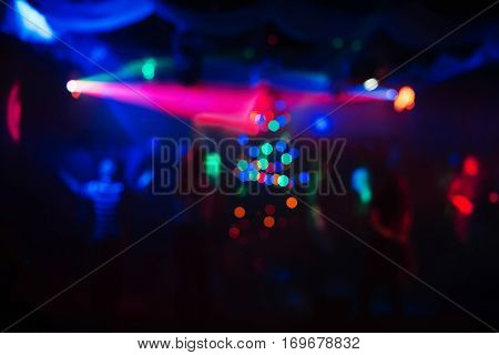 abstract colorful background in a night club with soft lasers and the lights from the Christmas tree