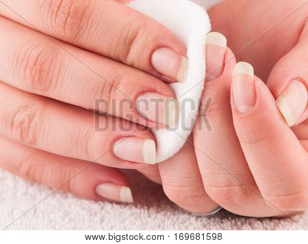 Woman using cotton pads to remove nail polish