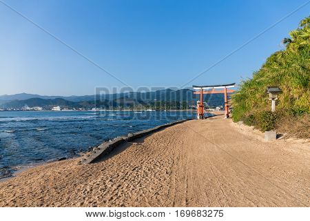 Red Torii in Aoshima Shrine with sunshine