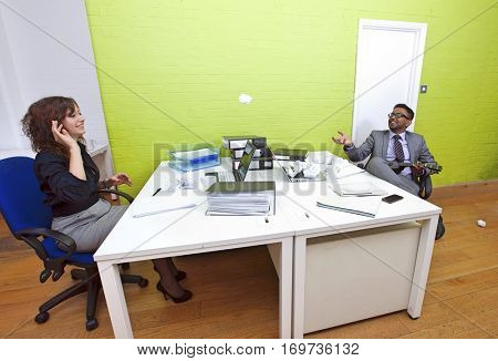 Colleagues throwing crumpled paper to each other