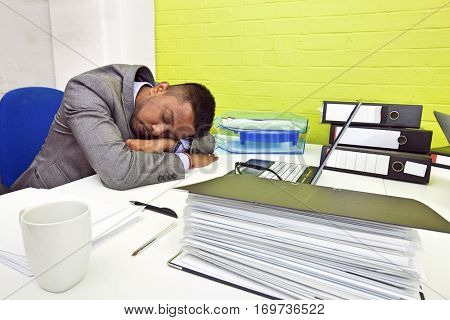 Indian businessman asleep at his desk