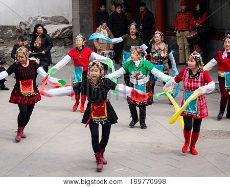 Beijing, China - March 8, 2015: Group Of Women Performing A Traditional Dance In Beihai Park On Inte