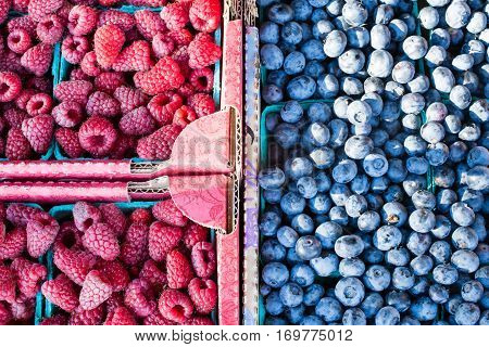 Raspberry And Blueberry Sold In Boxes On A Farmers Market
