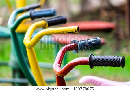 Children's bicycles 3 seats in the playground front focus blurred background